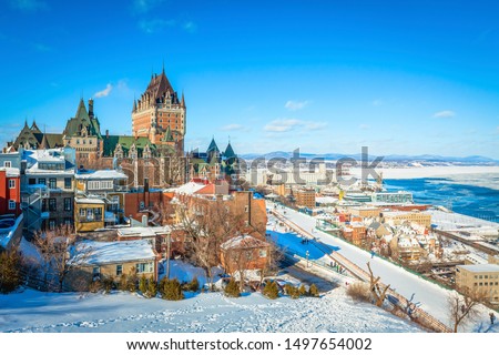 Panoramic cityscape view of Old Quebec City with iconic Chateau Frontenac and Dufferin Terrace against St. Lawrence river in winter, a national historic site of Canada, most famous landmark of Quebec. Royalty-Free Stock Photo #1497654002