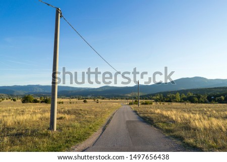 Beautiful sunny summer day in Croatia, Nice nature and landscape photo with a road. Calm, peaceful and happy outdoors picture.