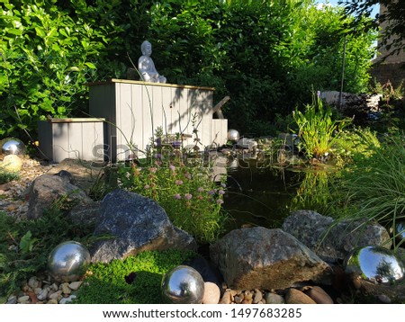 wildlife pond with buddha in Britain