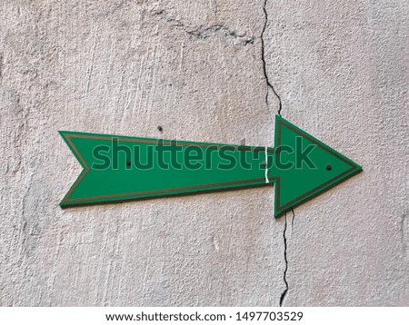 green sign direction indicator arrow on old wall Abstract pastel interesting differentsbuy different background image