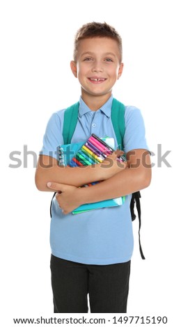 Cute little boy in school uniform with backpack and stationery on white background