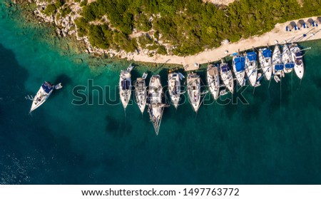 Aerial shot of anchored yachts and sailboats at Mongonissi port, Paxos, Greece