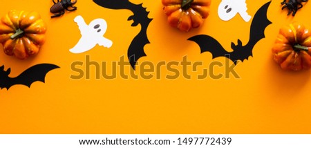 Happy Halloween holiday concept. Orange Halloween background design of Halloween decorations, pumpkins, bats, ghosts. Horizontal Halloween poster, party greeting card mockup, website hero header