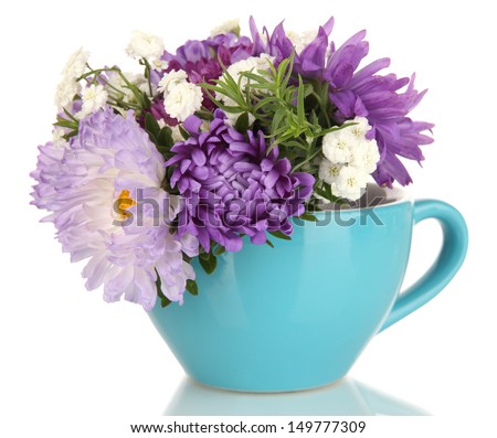 Beautiful bouquet of bright flowers in color mug, isolated on white