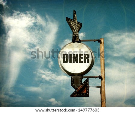 aged and worn vintage photo of diner sign with arrow                               