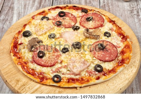 Pizza on an old wooden studio background
