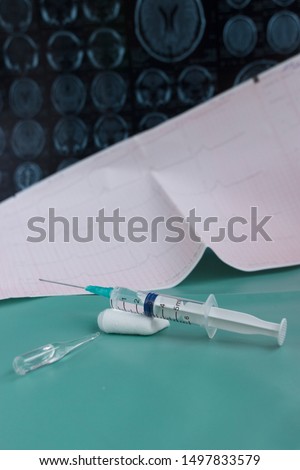 medical syringe with injection on magnetic resonance imaging background. diagram of the human brain