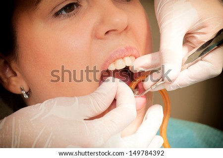 Selective focus on the needle in dentist hand