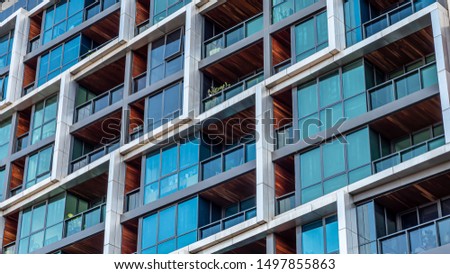 Modern multi-dwelling buildings, balconies close up. Family apartments in a strata living scheme of common property. Royalty-Free Stock Photo #1497855863