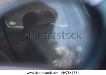 A Reflected view of a Seat in a Car