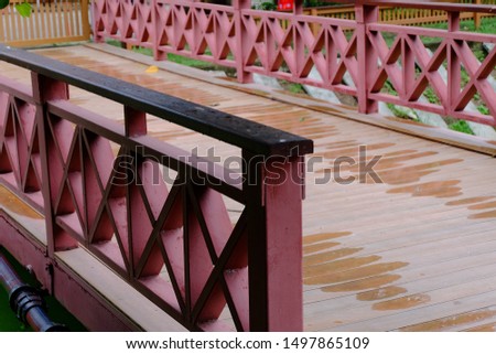 A bridge crossing stream the structure is metal in red
