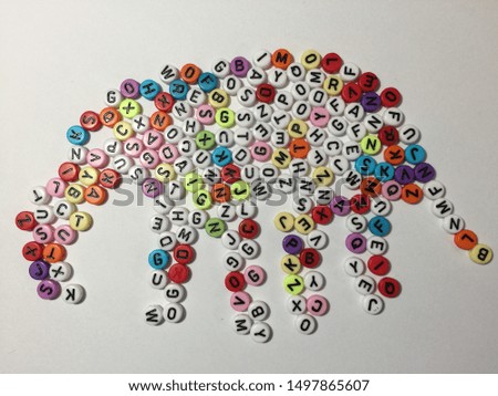 Small, multi-colored plastic beads arranged in an elephant shape.