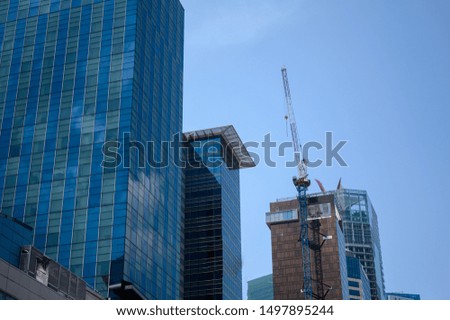 Building crane and buildings under construction in the city.