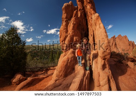 Mom and her son climbing rocks