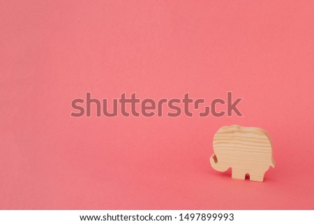 Wooden Elephant on Pink Background