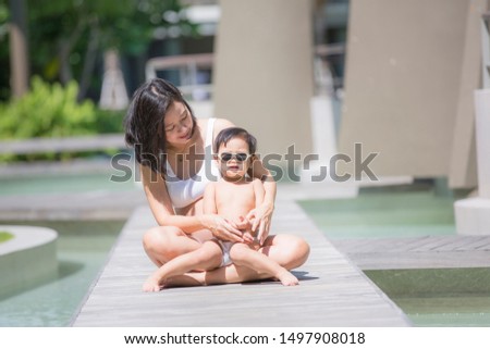 Asian pregnant women with her son felling relax on resort.