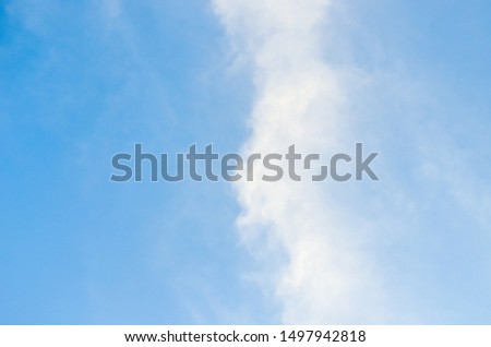 The blue sky and white clouds that resemble the waves of the sea in the morning, cool and shining with wind. it photo is two tone image