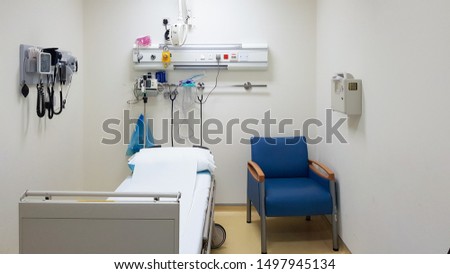 Empty hospital room with one bed, one chair and medical instruments on the wall. Health care concept. Medical room template