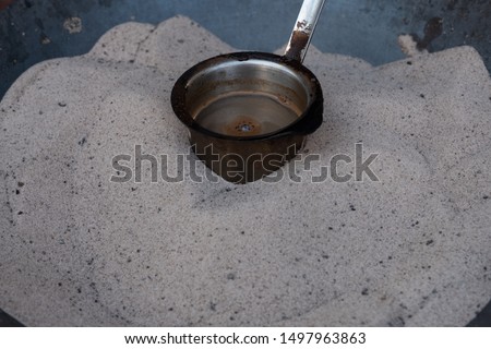 Preparation of desert arabic coffee on hot sand