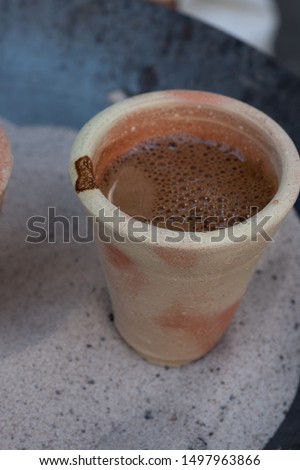 cups of desert arabic coffee on hot sand
