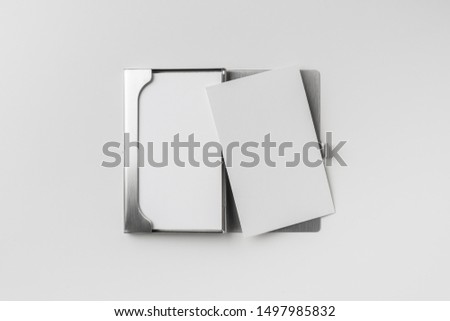 Design concept - top view of vertical business card with stainless steel case isolated on white background for mockup, it's real photo, not 3D render