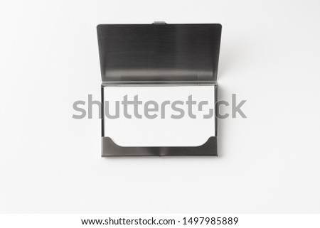 Design concept - top view of horizontal business card with stainless steel case isolated on white background for mockup, it's real photo, not 3D render