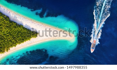 Croatia, Hvar island, Bol. Aerial view at the Zlatni Rat. Aerial view of luxury floating boat on blue Adriatic sea at sunny day. Travel - image Royalty-Free Stock Photo #1497988355