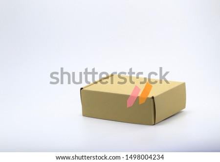 rectangle Cardboard box with post it mark for Parcel Delivery isolated on white background