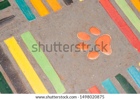 Ceramic tile flooring and dog foot print. Construction material texture.