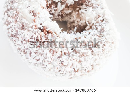 Piece of chocolate coconut donut up close, stock photo