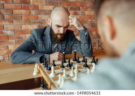 Male chess players playing, thinking process