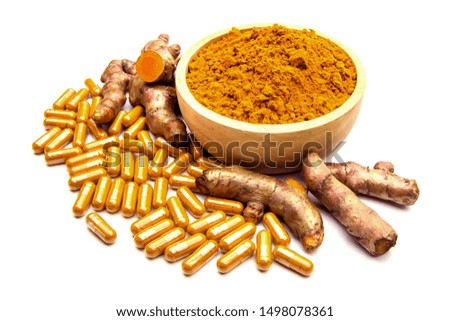 Raw Turmeric (Curcuma longa Linn) herbal,curcuma powder in wooden cup and turmeric capsules isolated on white Background.