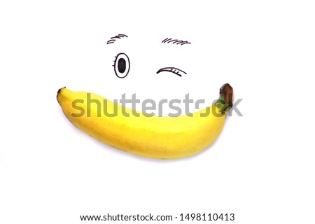 Banana make smiling face on white paper with black eyes written