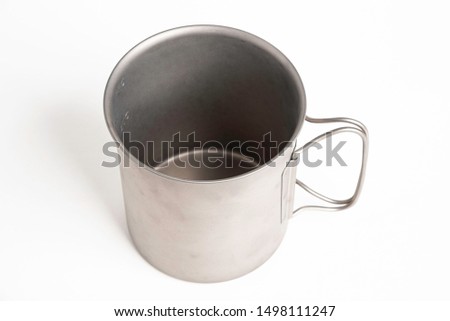 An all-metal multiple purpose mug with flexible handle and measuring mark set on a plain white background.