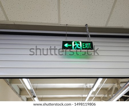 Illuminated green exit sign or fire escape sign. 