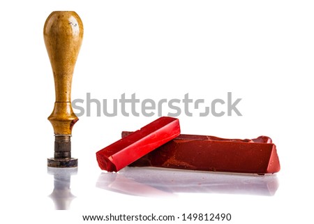 red sealing wax sticks, a wooden seal and an envelope isolated over a white background