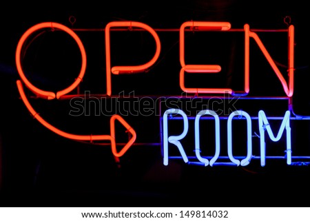 An open room neon sign in the black dark