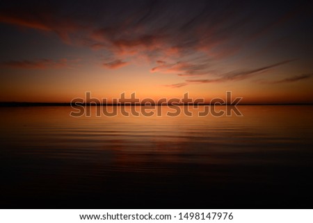 Romantic sky in twilight glow after sunset in beautiful colors of a light orange palette of light and shadows
