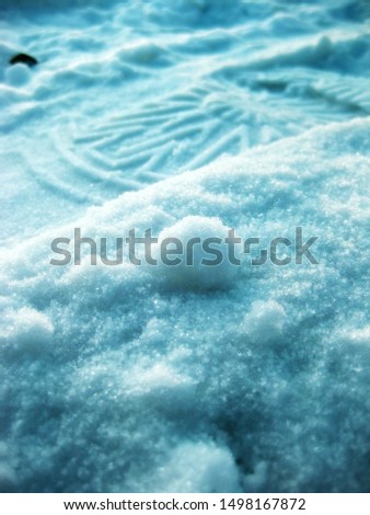 Colorful picture of a footprint on snow in a cold winter day in white and blue atmosphere