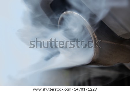 From a car exhaust flow polluting exhaust gases. Concept diesel and gasoline as environmental problem. Royalty-Free Stock Photo #1498171229