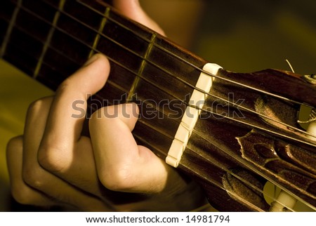 Close up of a hand playing guitar