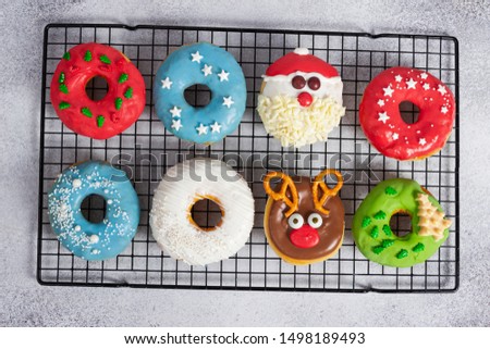 Set of Christmas donuts on baking rack on gray stone background. Christmas and New Year celebration concept. Top view.