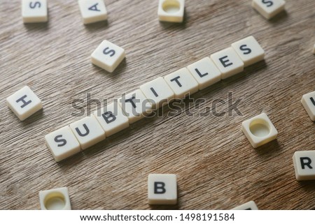 Subtitles alphabet square on wooden background. 