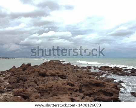 Picture of a beach on a sunny day with a stone barrier at the beach Rayong, Thailand