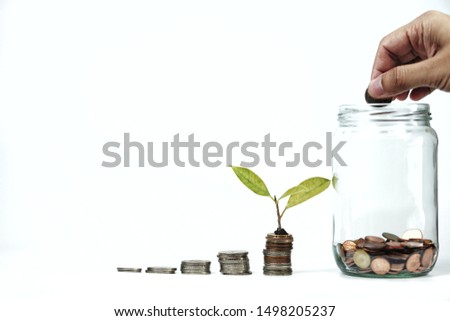 Hand and money coins - financial freedom concept,  white background. Royalty-Free Stock Photo #1498205237