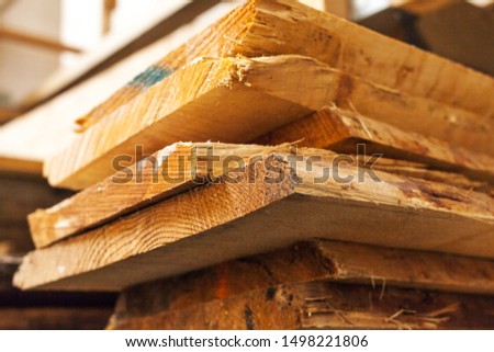Stack of wood with wooden boards for further processing in wood workshop carpentry solid wood
