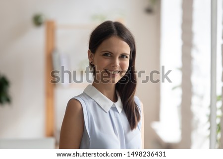 Headshot profile picture of confident young woman bank specialist or coach stand looking smiling at camera, happy positive millennial female employee or worker posing making photo, shooting for album Royalty-Free Stock Photo #1498236431