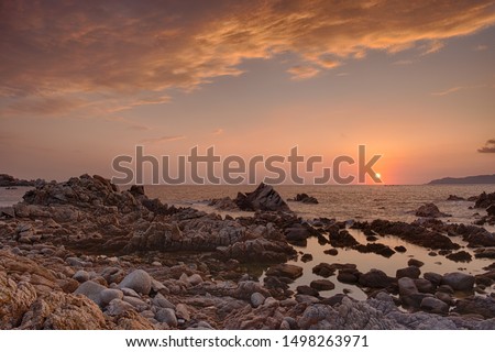 this picture was taken in the gulf of Valinco in Corsica. At the west end of the small village of Porto Pollo, there is a seal bay called La Punta. The sunsets on the rocky beach are wonderfull.