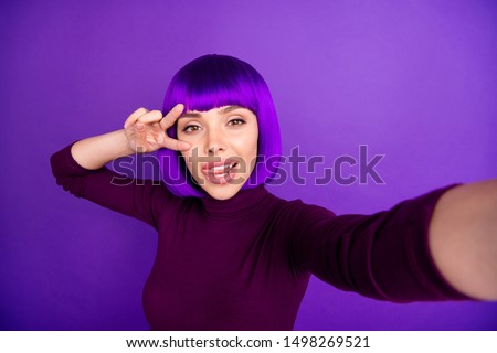 Coquette lady making self photos sticking tongue out mouth showing v-sign wear trendy clothes isolated purple background