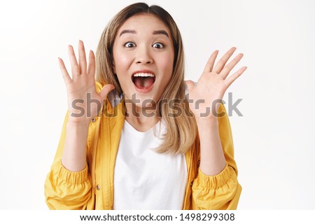 Emotive excited screaming asian blond girl yell about amazing shocking surprising great news shaking hands astonished smiling joyful delighted open mouth gasping incredible excellent opportunity